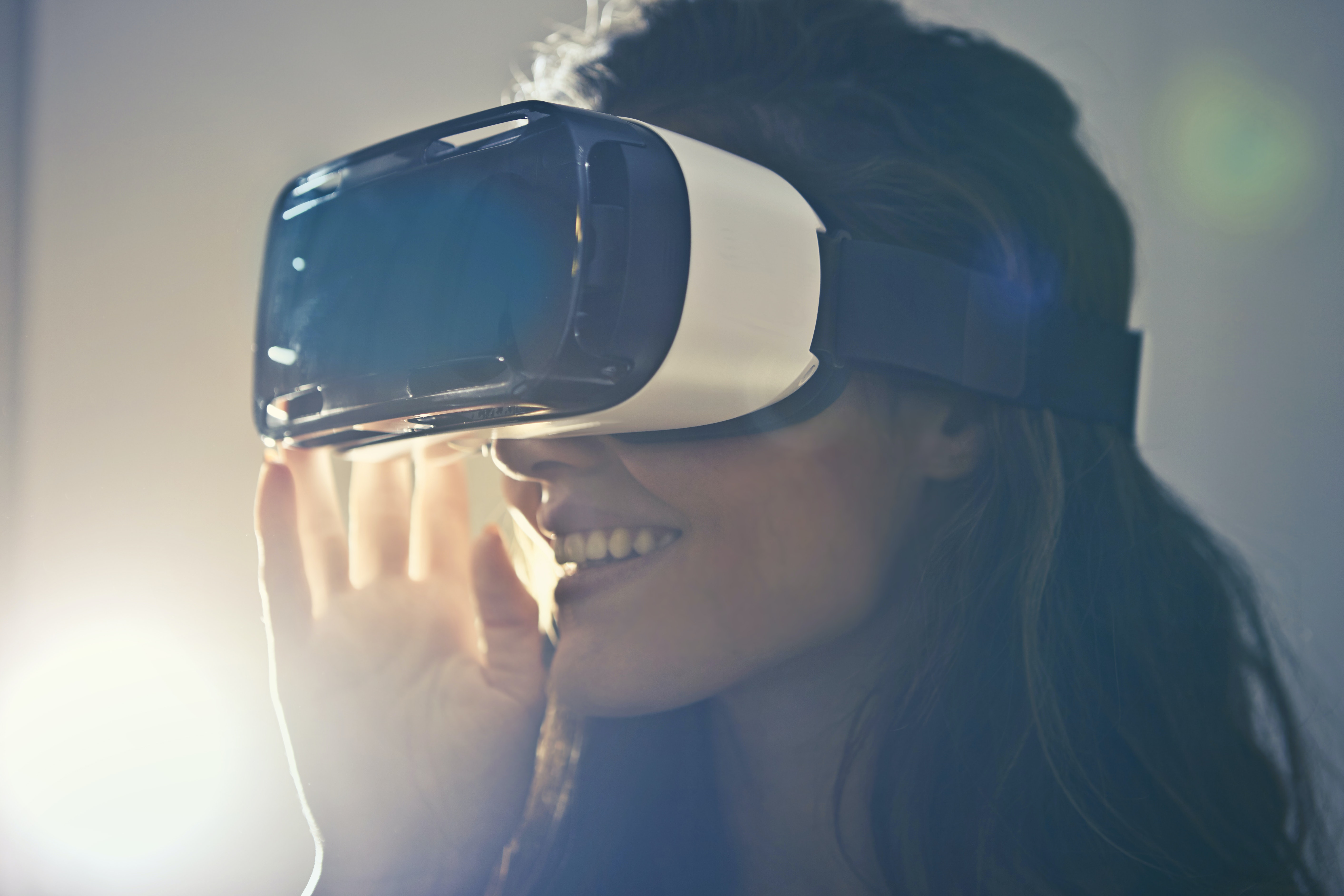 A smiling woman with a VR device on her head